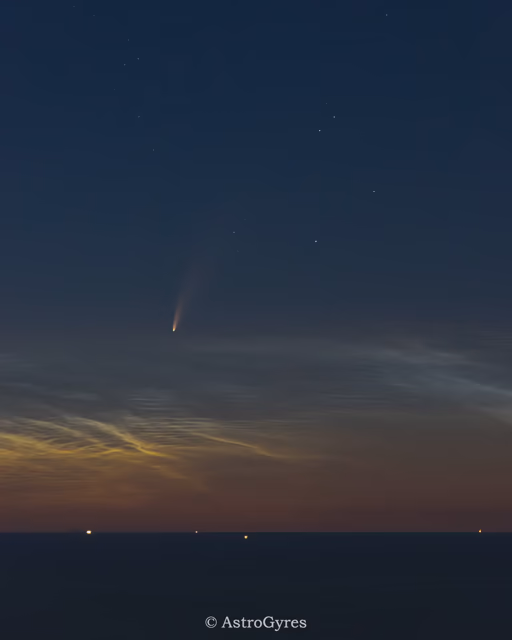 Comet in the sky low to the horizon above the clouds.