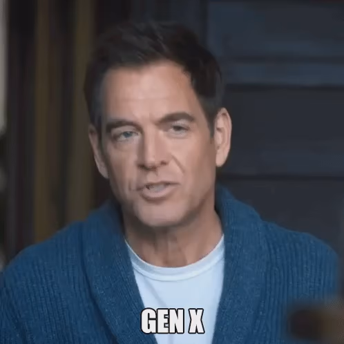 Animated gif of a middle aged white man with short, dark hair. He is wearing a white t-shirt under a blue jumper. He is captioned saying "Gen X" and then "The forgotten generation"