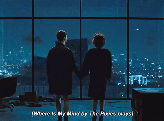 Animated gif of the end scene in Flightclub where Edward Norton and Helena Bonham Carter look at each other as the building are crash down and The Pixies -where is my mind, is playing.